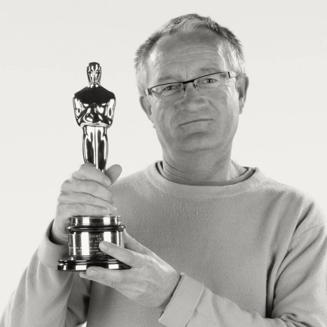 Image of 'Avatar' Production Designer Kim Sinclair holding an Oscar award.