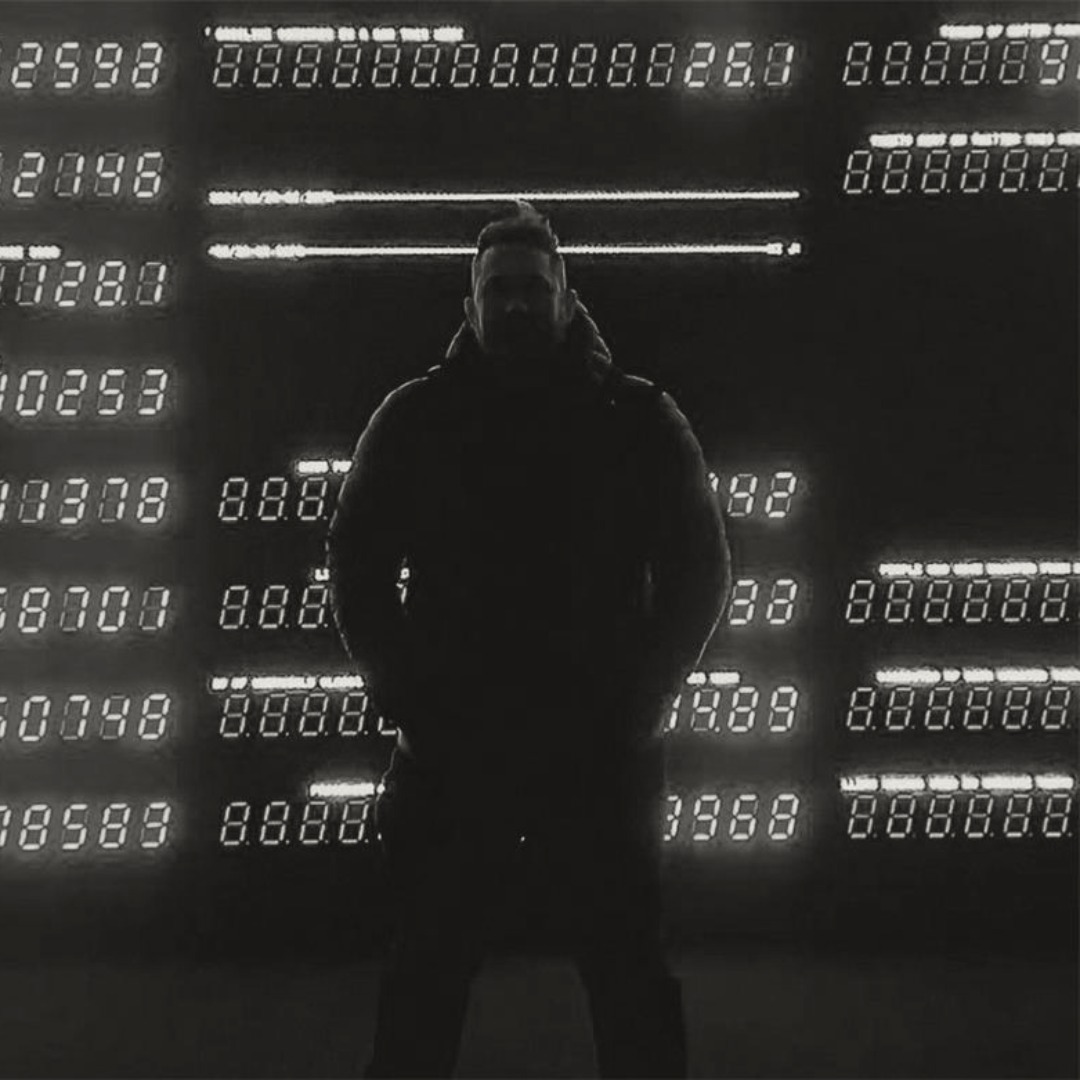 Andy Ellis standing in front of an installation displaying lights and numbers.