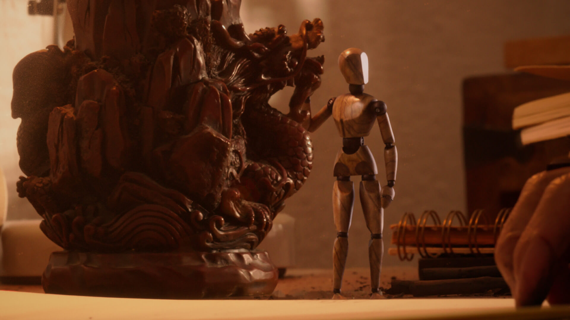 A wooden character standing next to a wooden statue