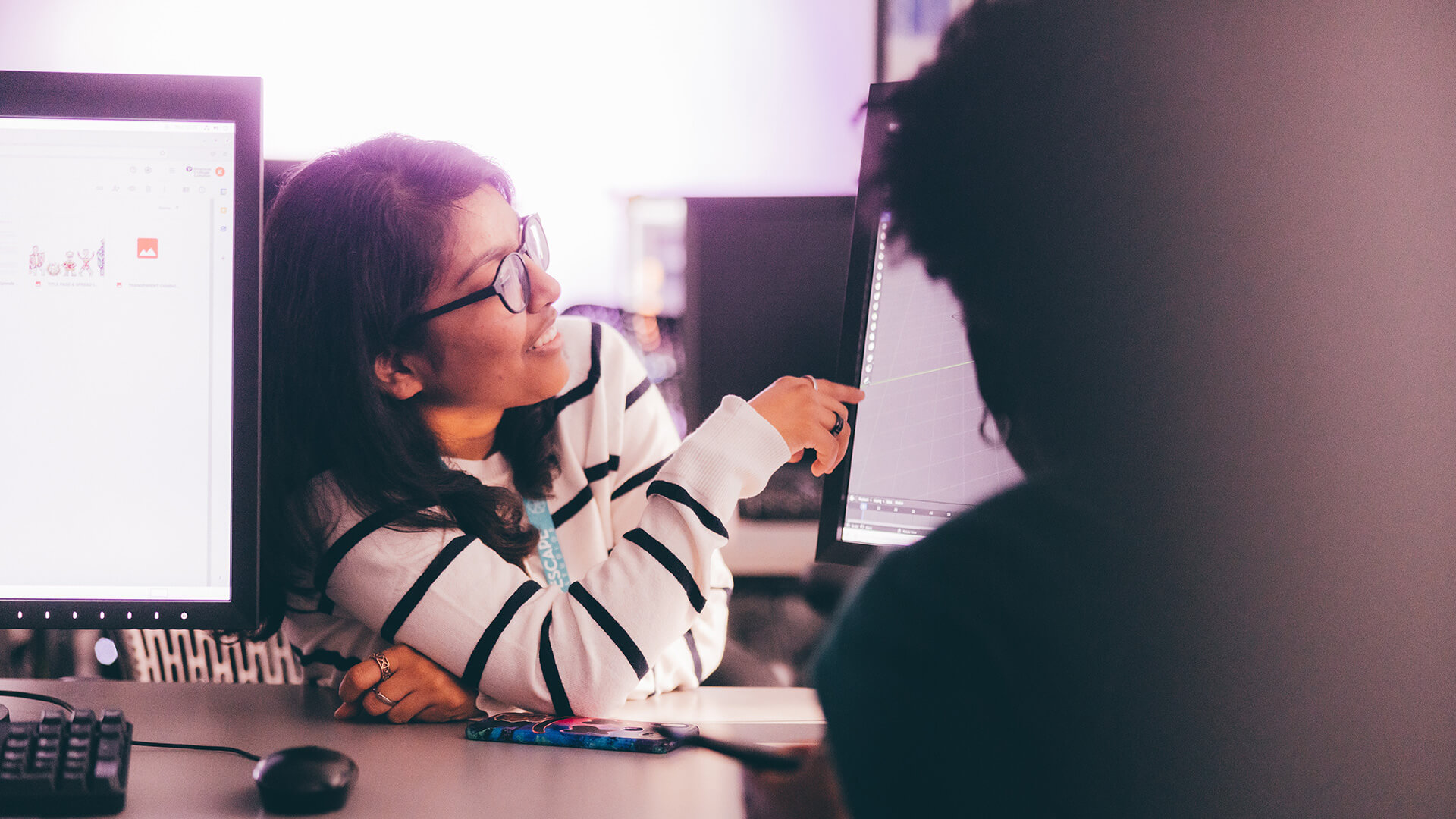 Female student pointing at computer screen