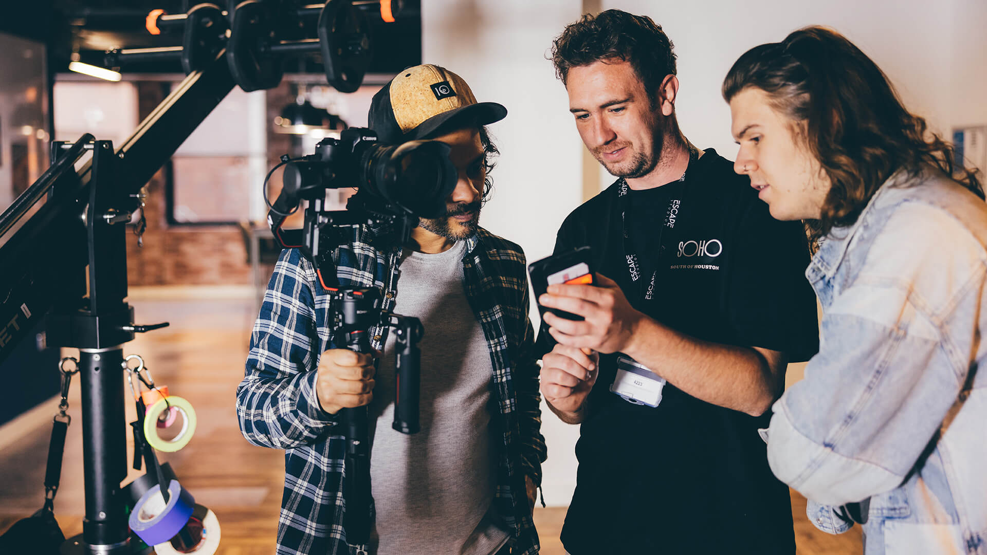 Three male students looking at phone