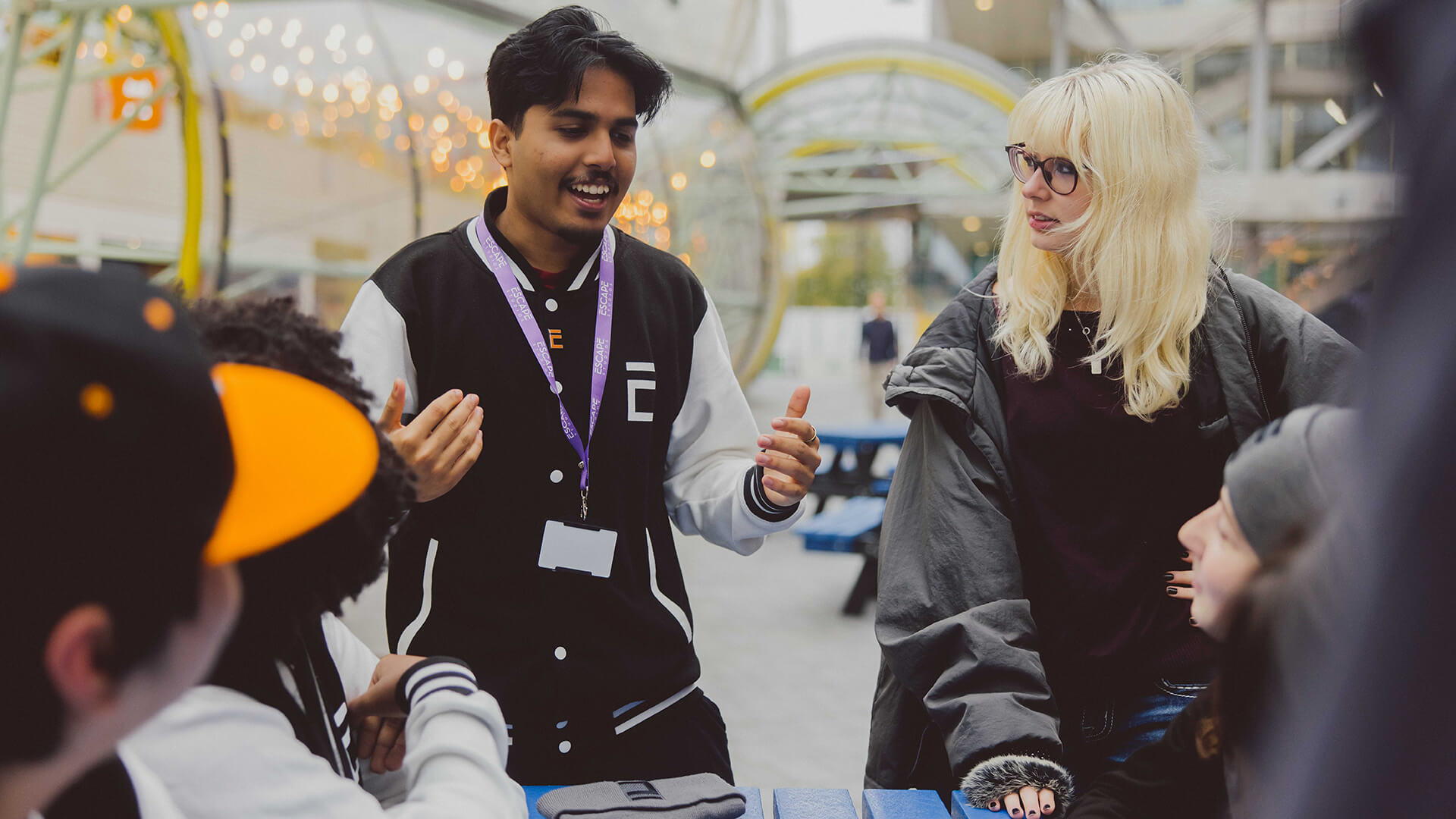 Group of five students talking near the canteen