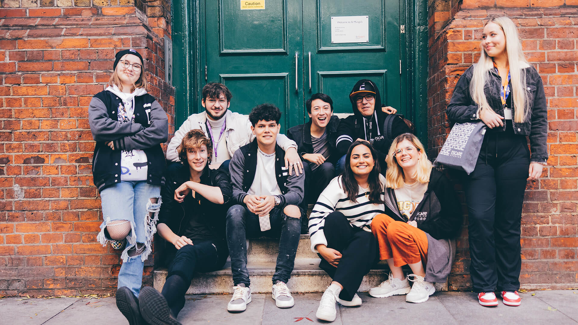 Group of students sat in doorway
