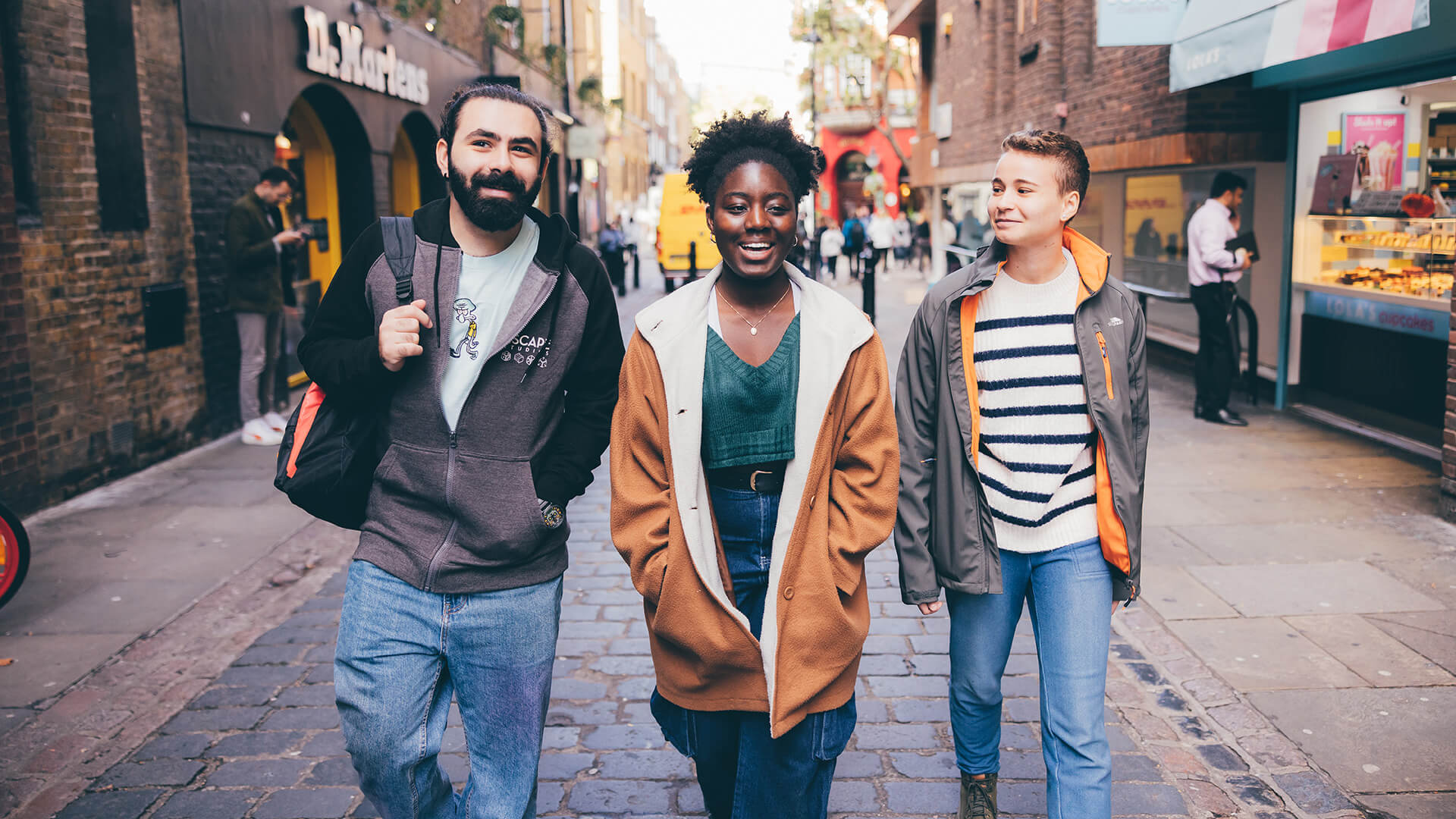 Three students walking down the street