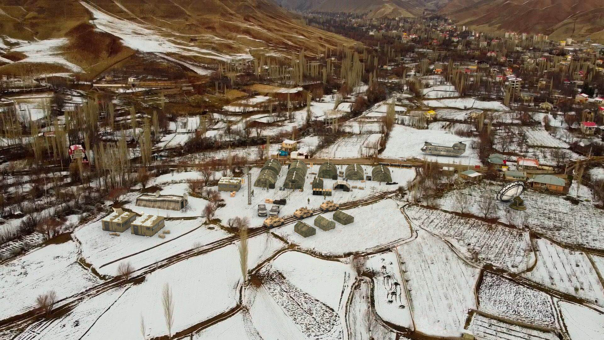 Image shows a snowy landscape from above. A realistic military base has been added to the scene using VFX. Student work by Hamid Lotfi.
