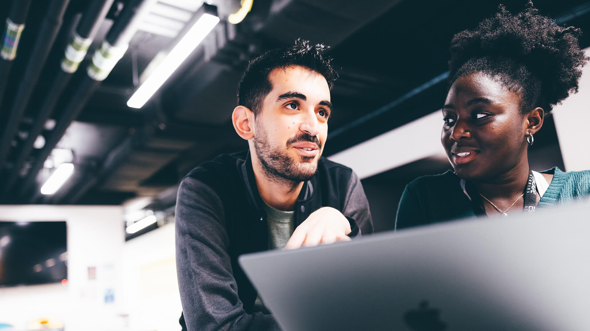 Students chatting behind a laptop