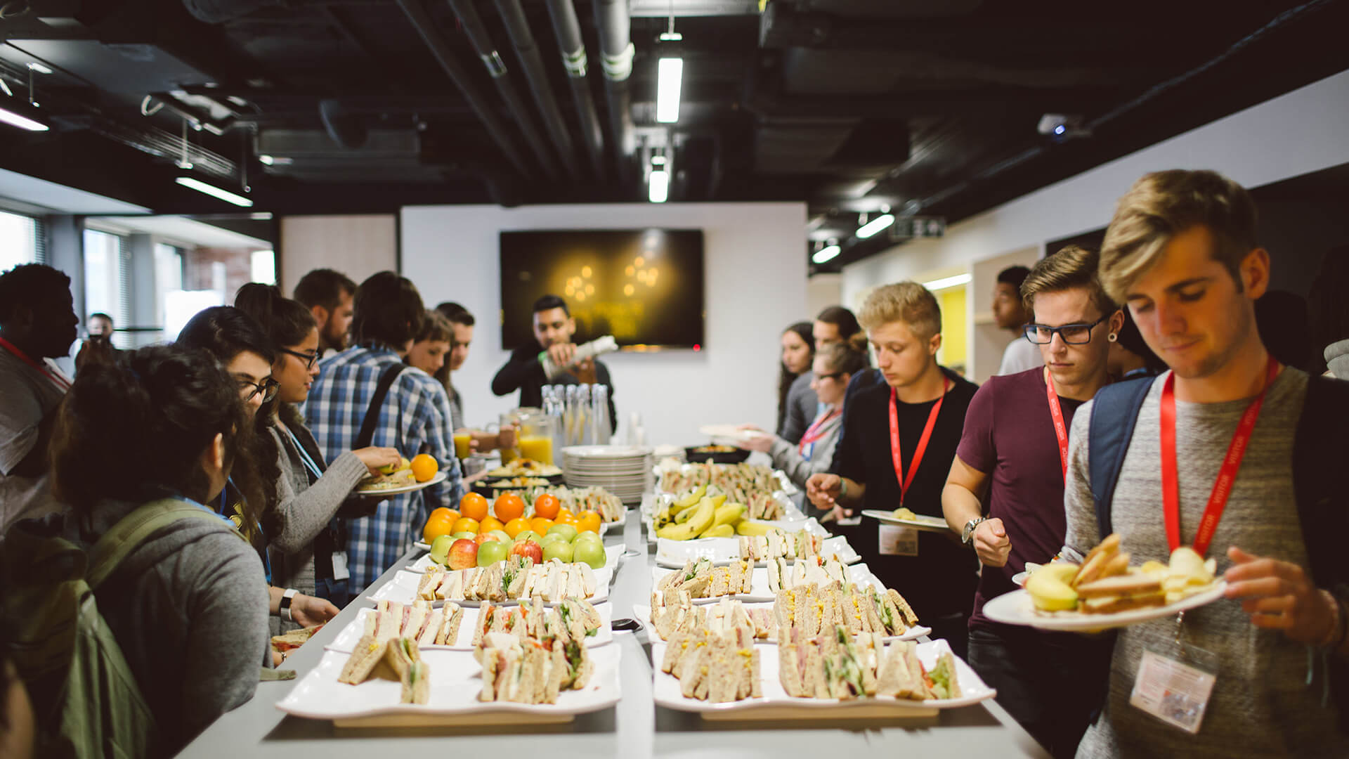 Students walking around table of food