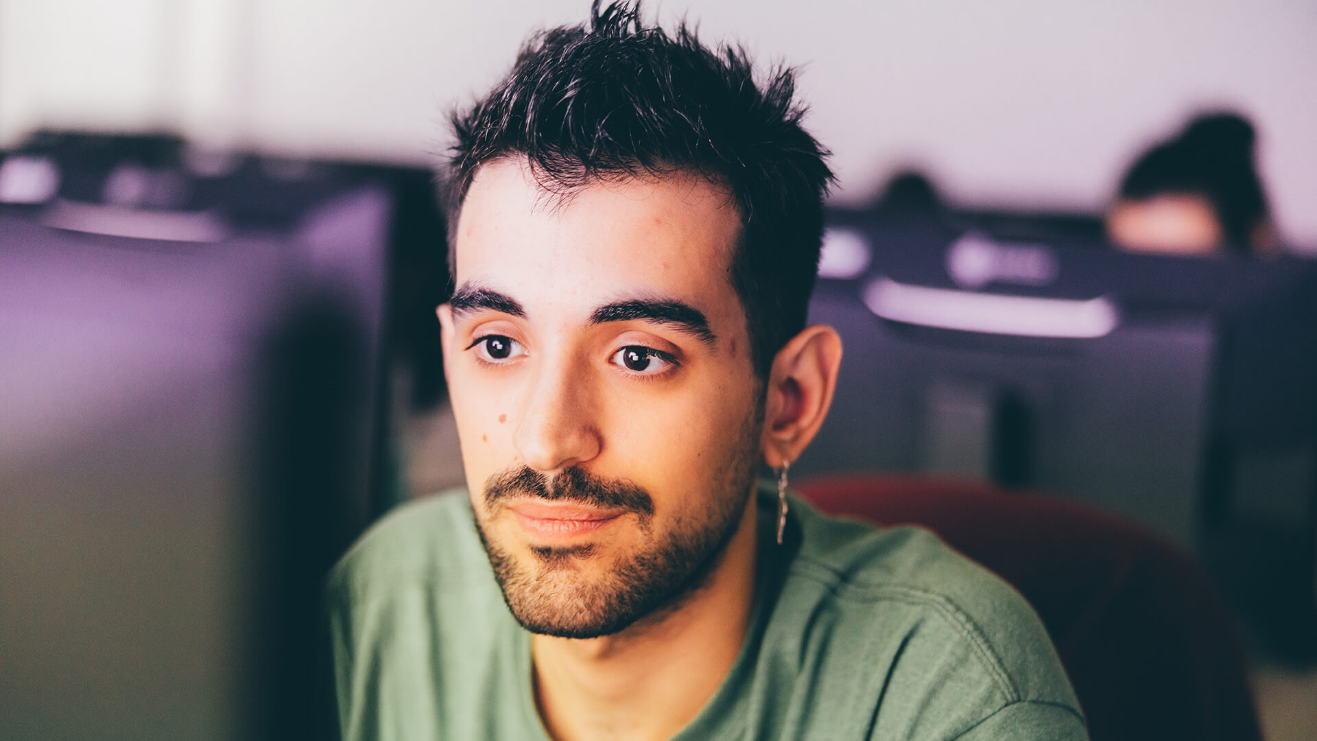 Male student looking at computer monitor