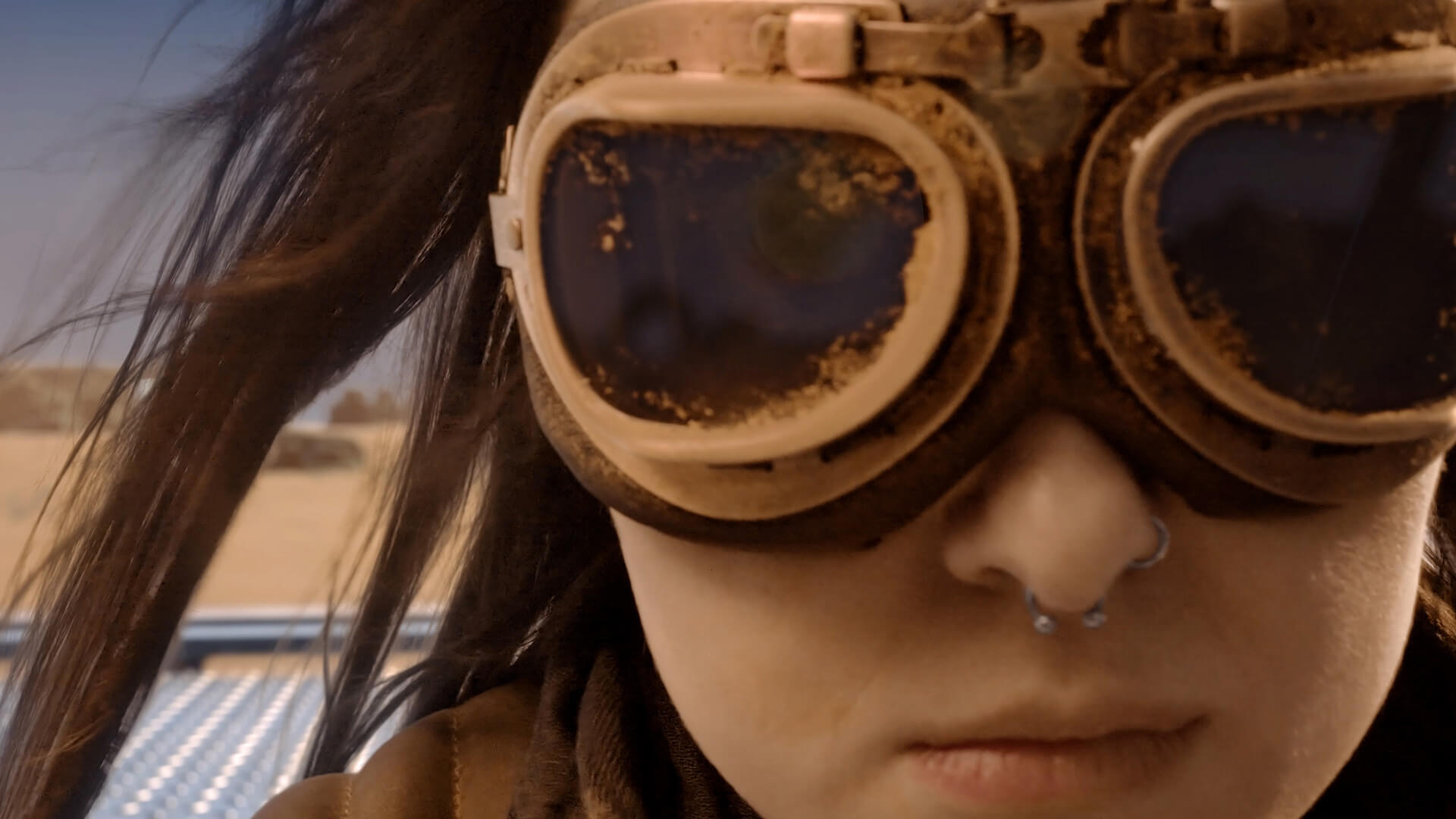 A close up of a females face wearing protective goggles