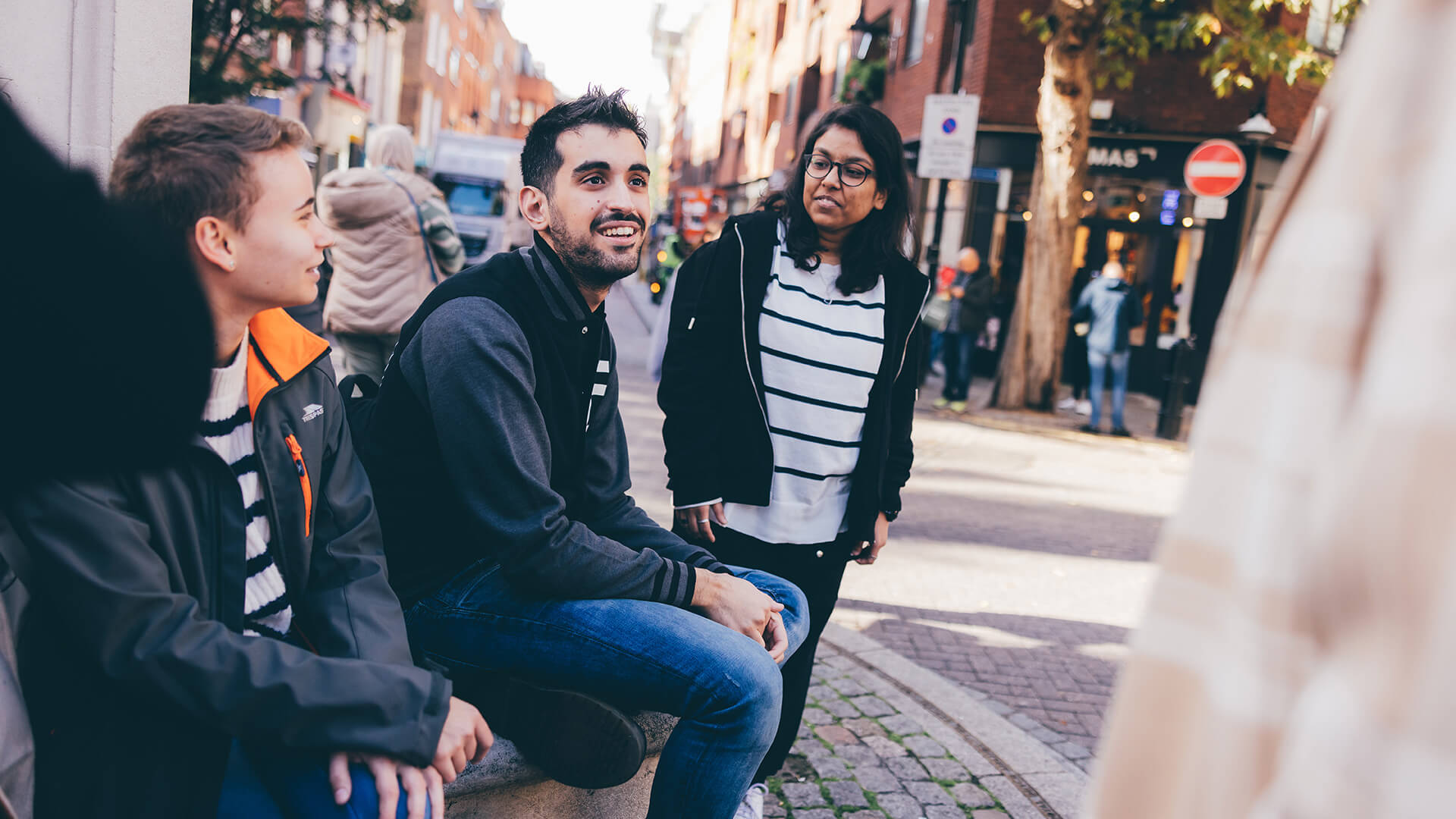 Students talking on stone bench