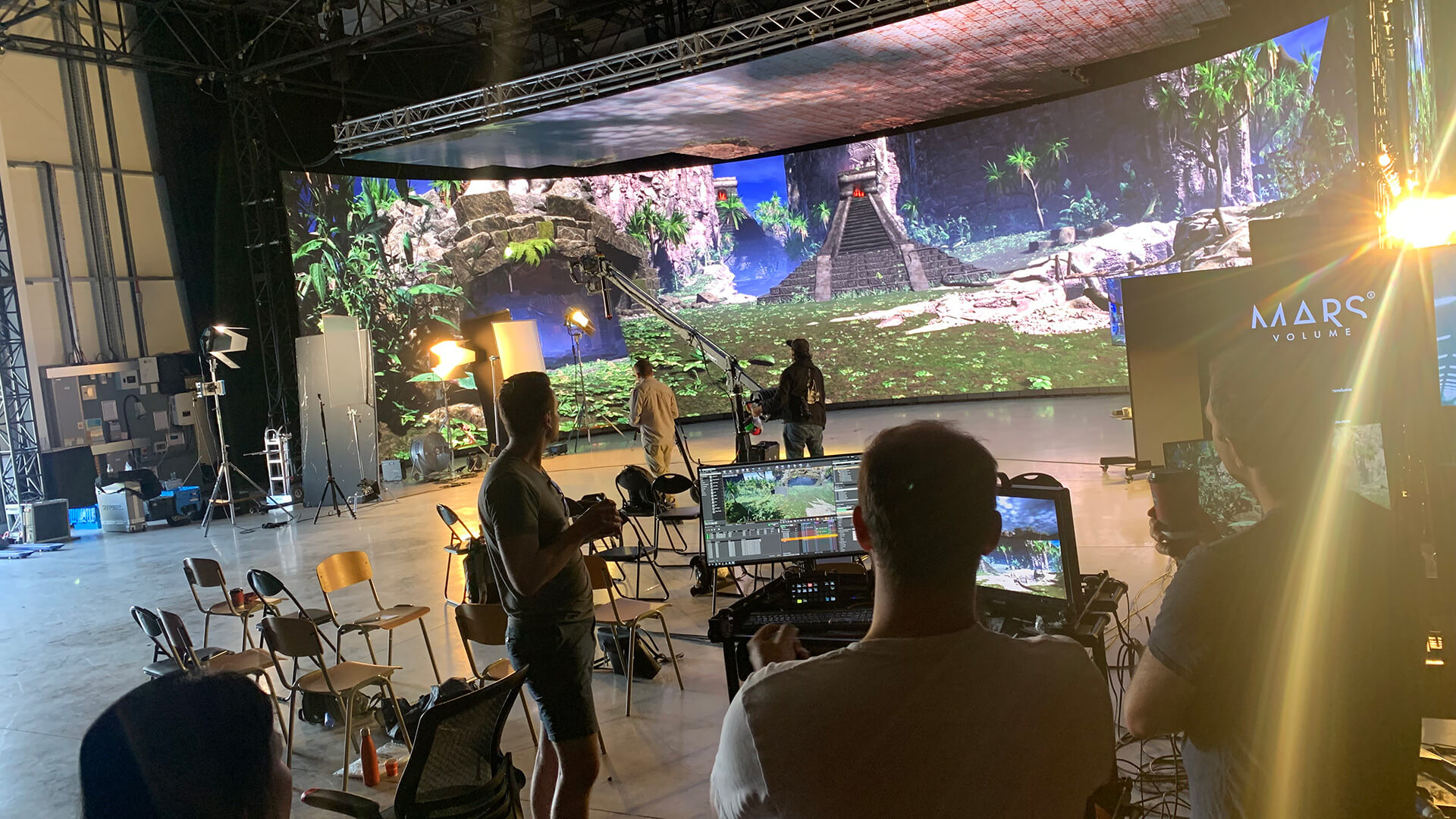 South American temple on large screen behind camera equipment