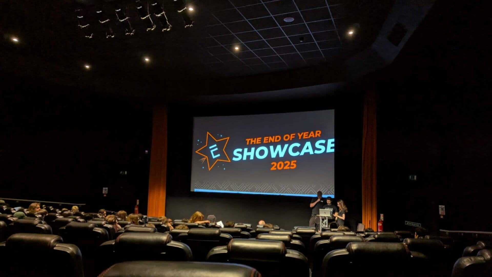 A cinema screen with the words "The end of year showcase 2025"