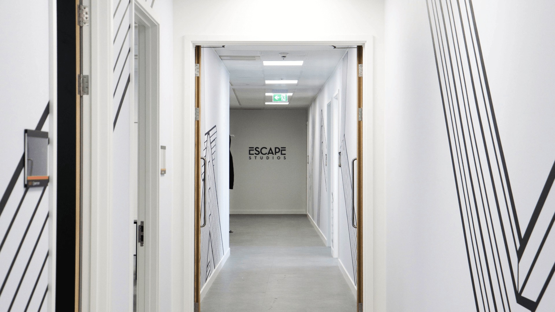 Corridor on campus with wall art and logo sign on the wall in the background