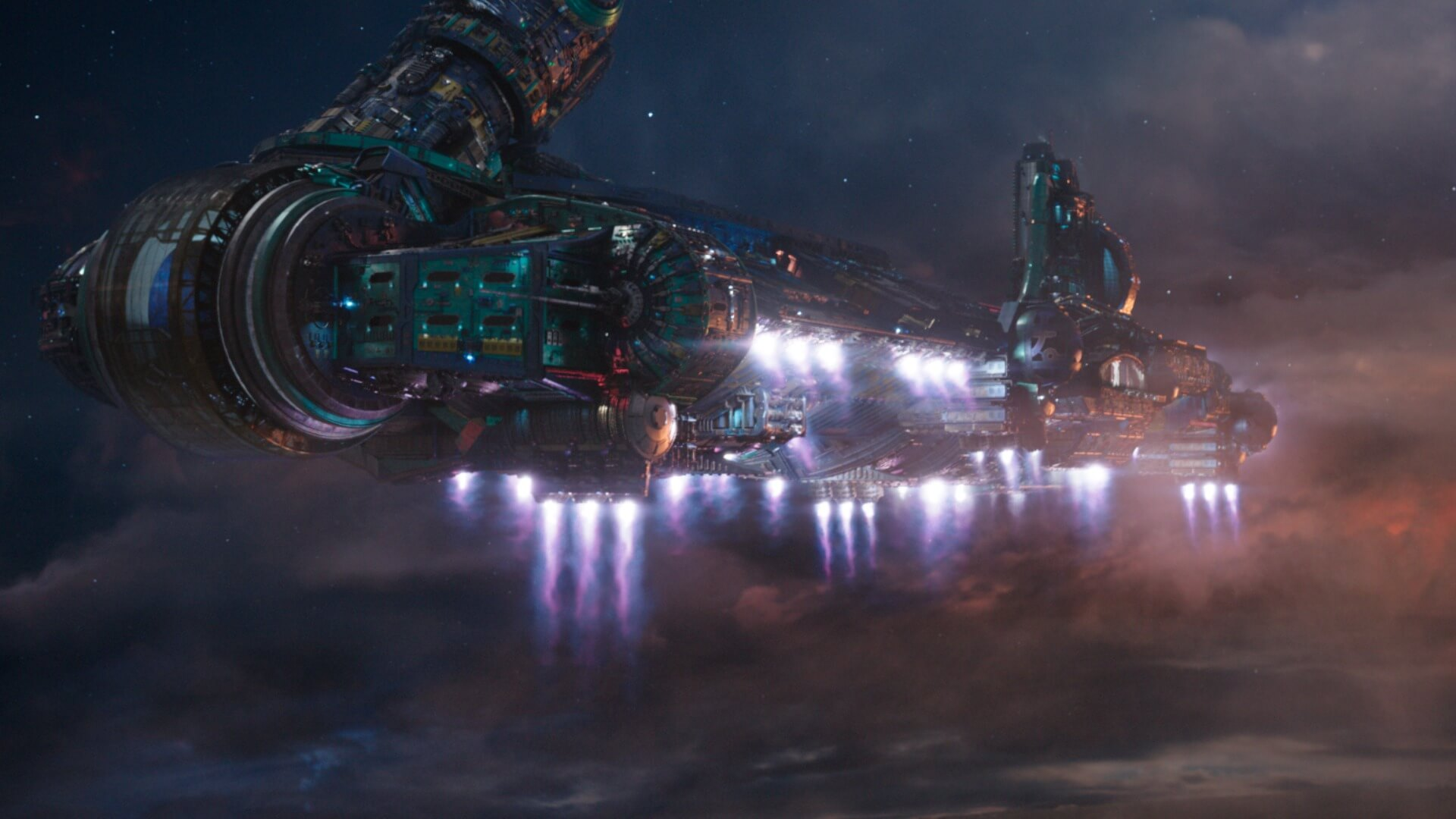 A glowing spaceship flies through a dark cloudy sky.